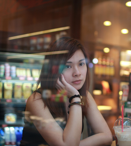 A Young Lady sitting in a cafe